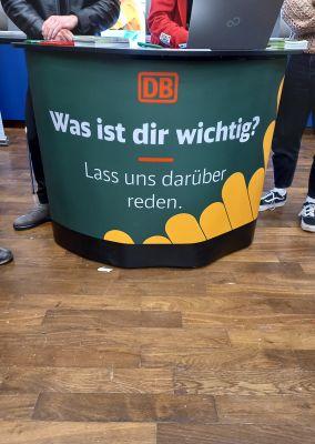 Grüner Thekenstand der DB mit der Aufschrift „Was ist dir wichtig? Lass uns darüber reden.“